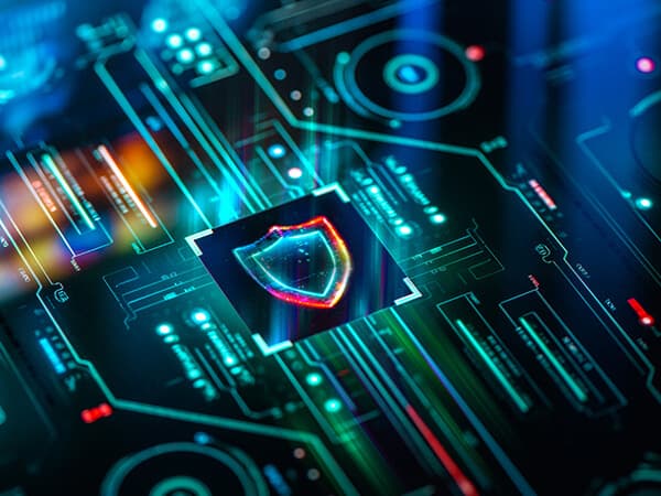 Business D Dos mitigation Features 600x450 Shield-looking image centered above a lighted circuit board